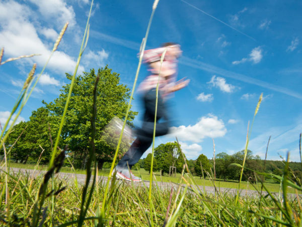 Man Jogging Through Field With Motion Blur